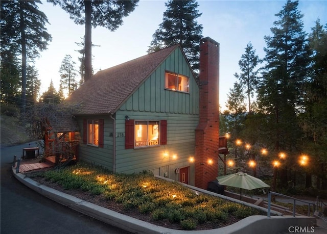 278 Mittry Ln, Lake Arrowhead, CA 92352 - view of side of home with board and batten siding, a chimney, and a shingled roof