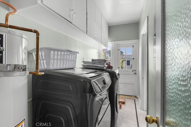 laundry room with cabinet space, washing machine and dryer, and light tile patterned flooring