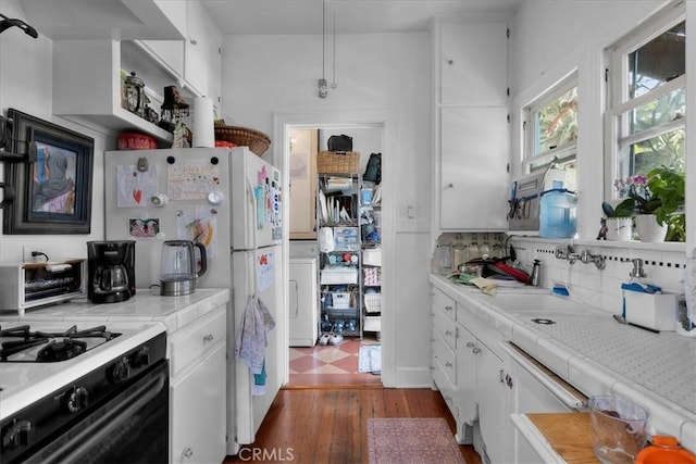 kitchen with backsplash, dark wood finished floors, a toaster, white cabinets, and tile counters