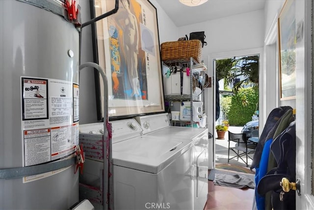 washroom featuring laundry area, washer and clothes dryer, and water heater