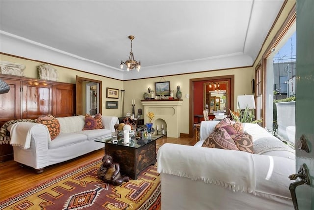 living room featuring a notable chandelier and wood finished floors