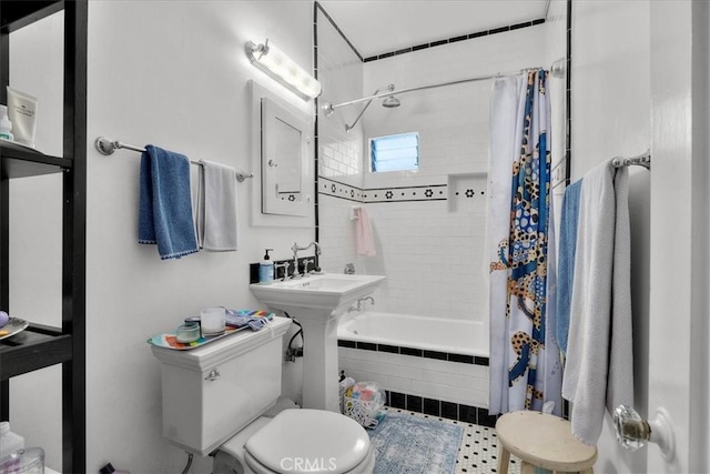 bathroom with tiled shower / bath combo and toilet