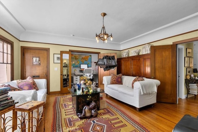 living room with light wood-type flooring and a notable chandelier