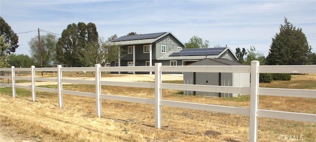 exterior space with fence private yard and roof mounted solar panels