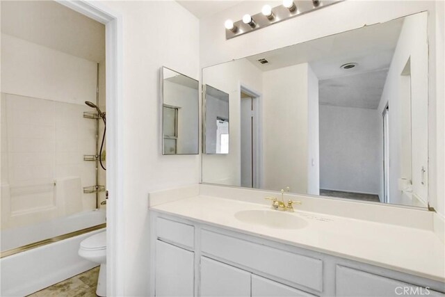 bathroom with vanity, bathtub / shower combination, and toilet