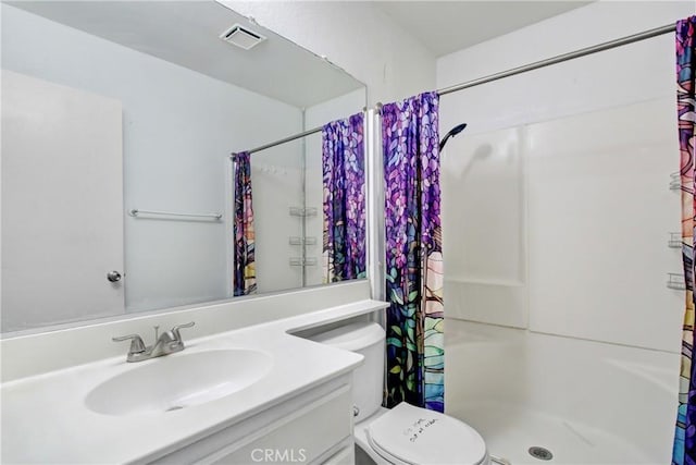 full bath with vanity, toilet, visible vents, and a stall shower