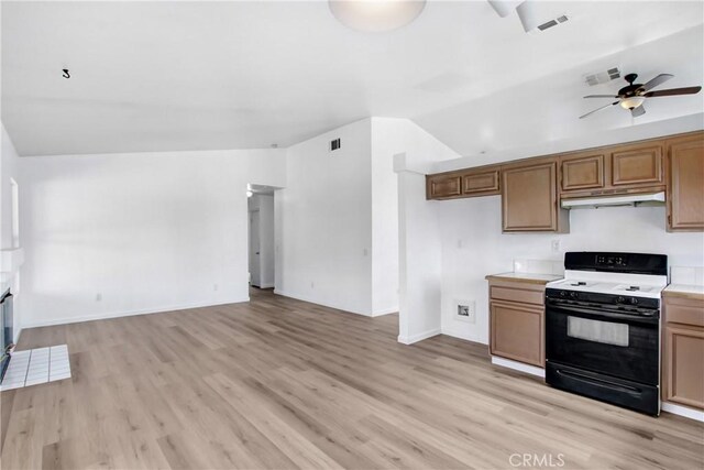 kitchen featuring ceiling fan, light countertops, light wood-style flooring, open floor plan, and gas range oven