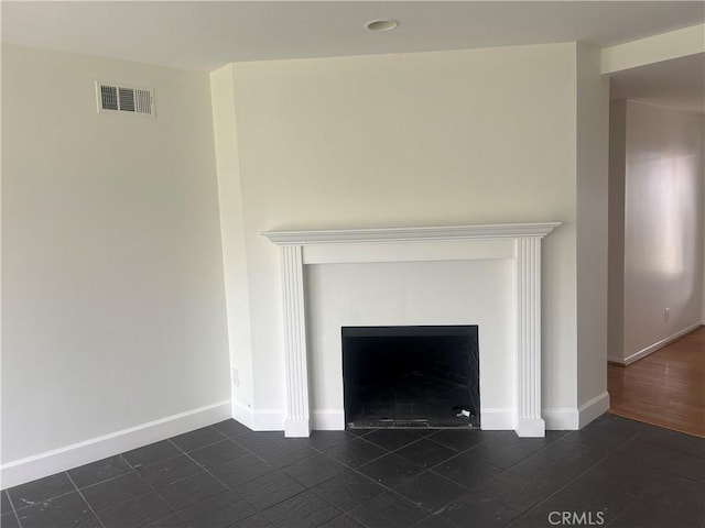 room details featuring a fireplace with flush hearth, baseboards, and visible vents