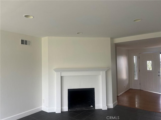 unfurnished living room with visible vents, recessed lighting, and baseboards