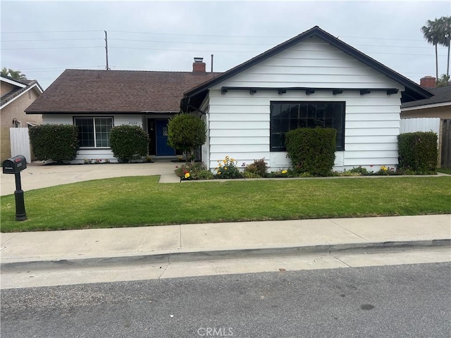 view of front of home featuring a chimney and a front lawn