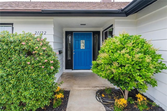 21122 Amberwick Ln, Huntington Beach, CA 92646 - view of exterior entry with a shingled roof