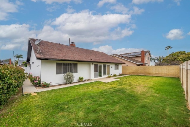 21122 Amberwick Ln, Huntington Beach, CA 92646 - rear view of property with a patio, stucco siding, a chimney, a fenced backyard, and a yard