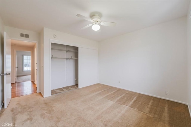 21122 Amberwick Ln, Huntington Beach, CA 92646 - unfurnished bedroom with a closet, light colored carpet, visible vents, a ceiling fan, and baseboards