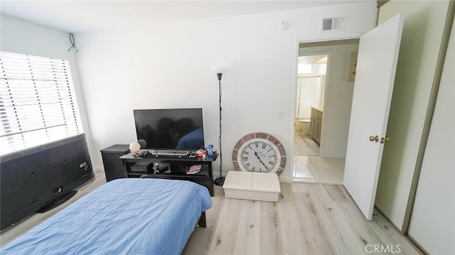 bedroom featuring light wood-type flooring and visible vents