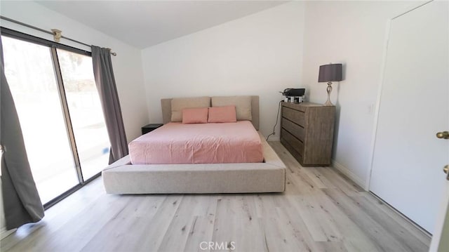 bedroom featuring access to outside and light wood finished floors