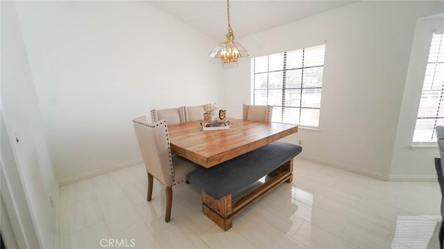dining area with baseboards, a chandelier, and a wealth of natural light
