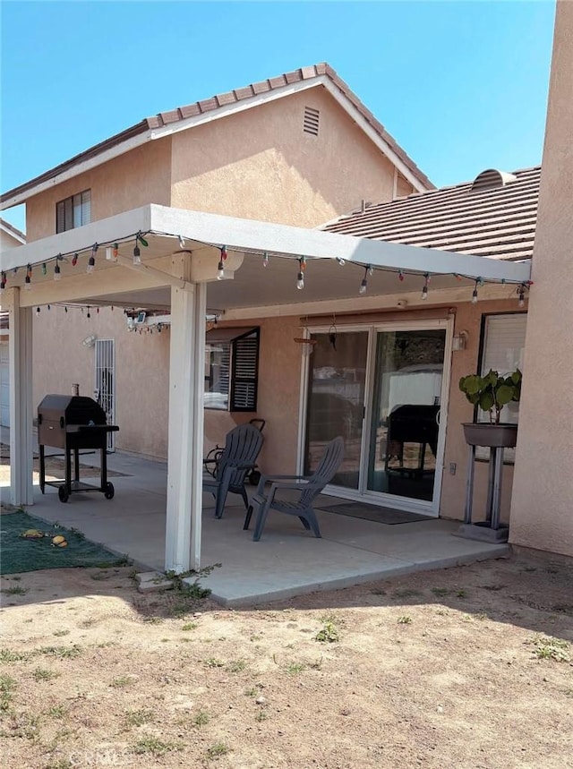 back of property featuring stucco siding and a patio area