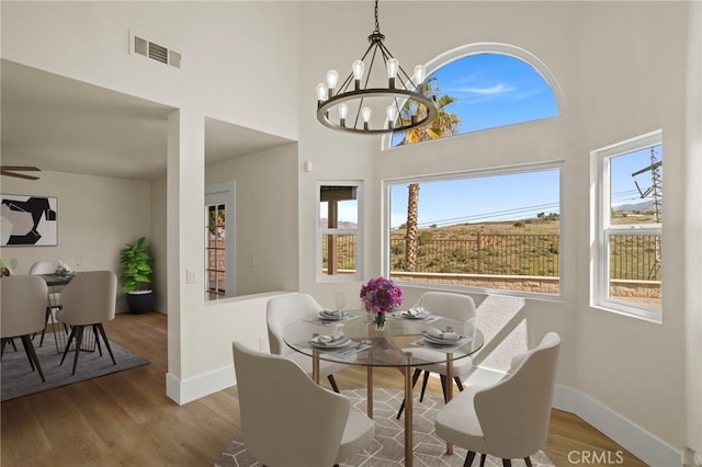 9239 Stone Canyon Rd, Corona, CA 92883 - dining room with a notable chandelier, visible vents, baseboards, and wood finished floors