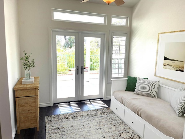 doorway to outside featuring baseboards, ceiling fan, french doors, and dark wood finished floors