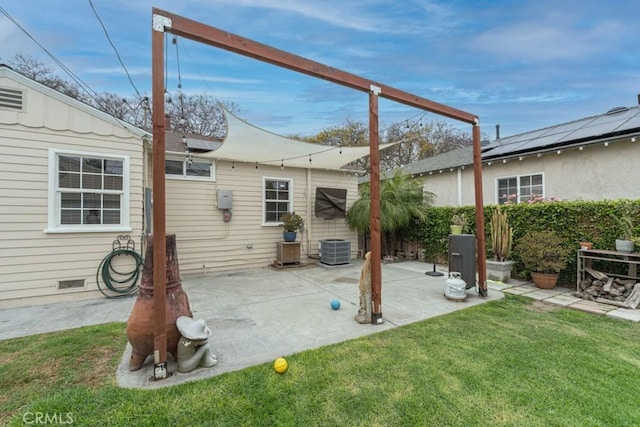 exterior space featuring central AC unit, a patio, and a lawn