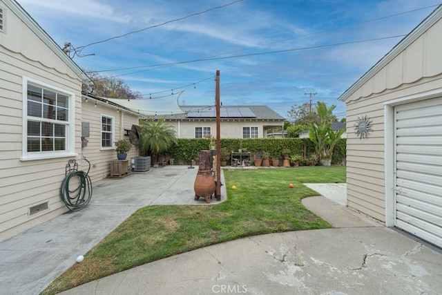 view of yard with a patio and central AC