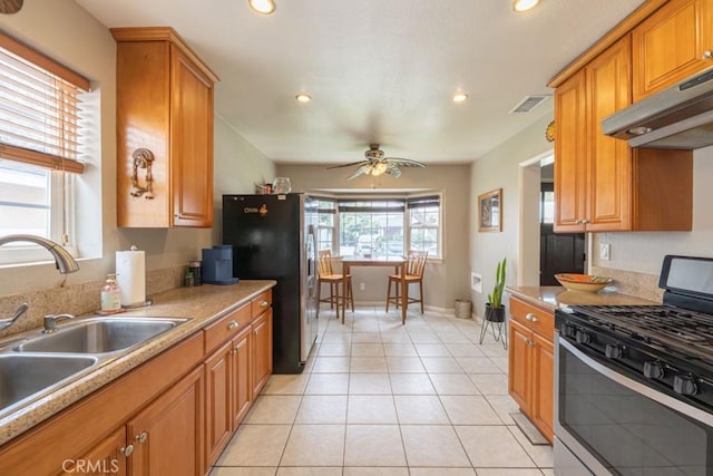 kitchen with a sink, visible vents, recessed lighting, under cabinet range hood, and appliances with stainless steel finishes