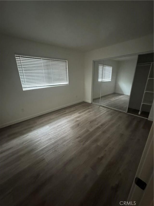 615 Calle Campana, San Clemente, CA 92673 - unfurnished bedroom featuring baseboards, a closet, and dark wood-style floors
