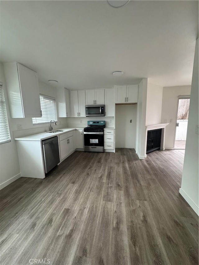 615 Calle Campana, San Clemente, CA 92673 - kitchen featuring a sink, appliances with stainless steel finishes, dark wood finished floors, and white cabinetry