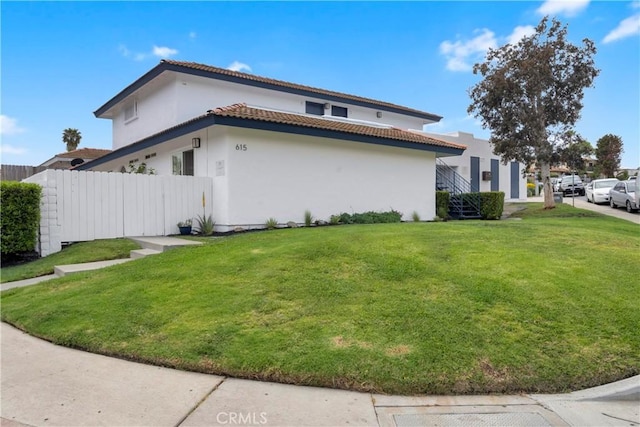 615 Calle Campana, San Clemente, CA 92673 - view of side of home with stucco siding, a lawn, fence, and a tile roof