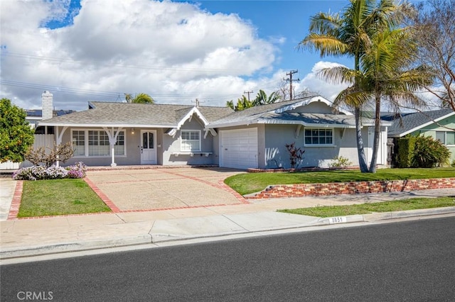 ranch-style house with an attached garage, a front lawn, stucco siding, and concrete driveway