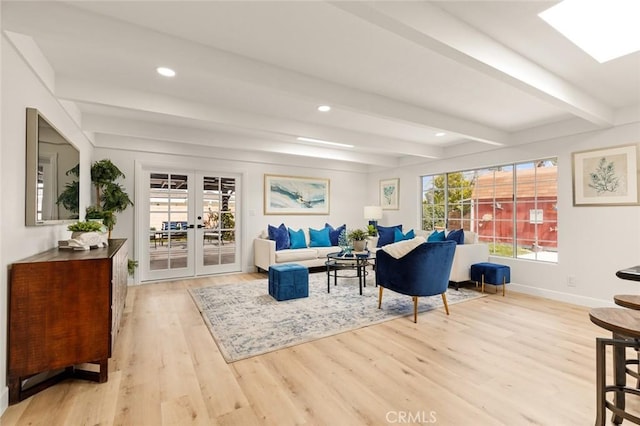 living room featuring french doors, baseboards, beam ceiling, and wood finished floors