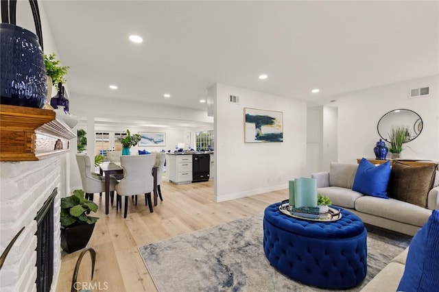living room with light wood-style floors, recessed lighting, and visible vents