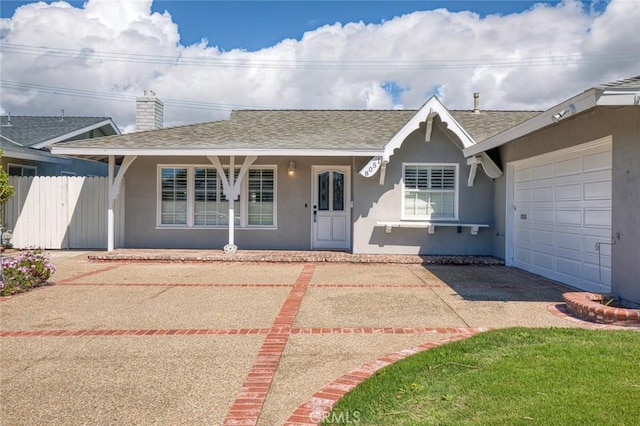 ranch-style house featuring roof with shingles, fence, an attached garage, stucco siding, and a chimney