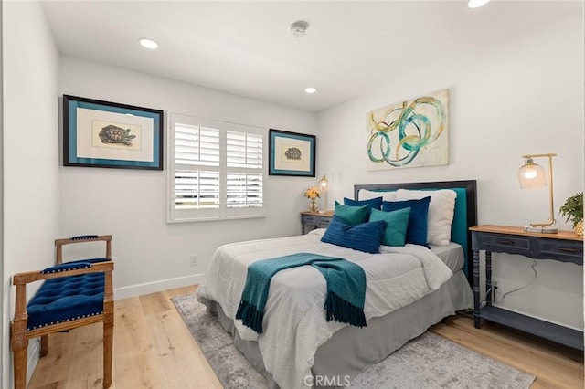 bedroom with baseboards, recessed lighting, and wood finished floors