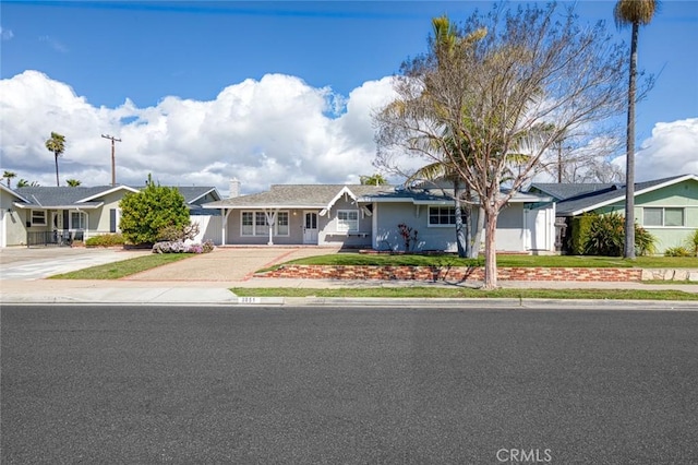 view of front of home featuring concrete driveway and stucco siding