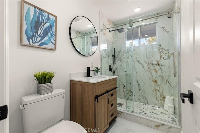 full bathroom featuring a marble finish shower, vanity, toilet, and marble finish floor