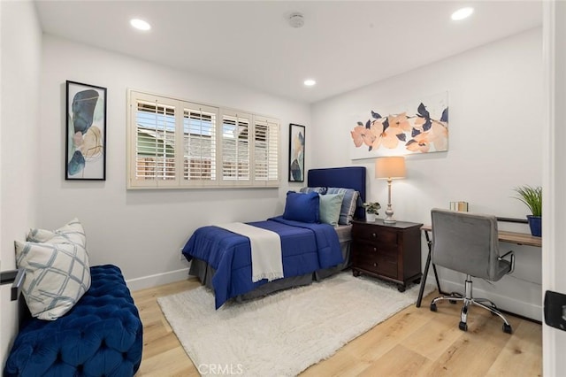 bedroom with recessed lighting, baseboards, and wood finished floors