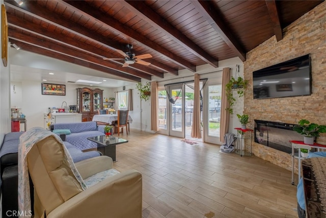 living room with wood finished floors, a fireplace, ceiling fan, wood ceiling, and lofted ceiling with beams