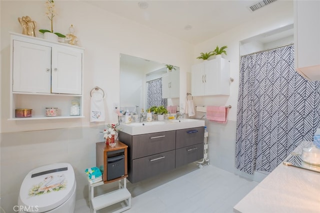 bathroom featuring vanity, curtained shower, and visible vents