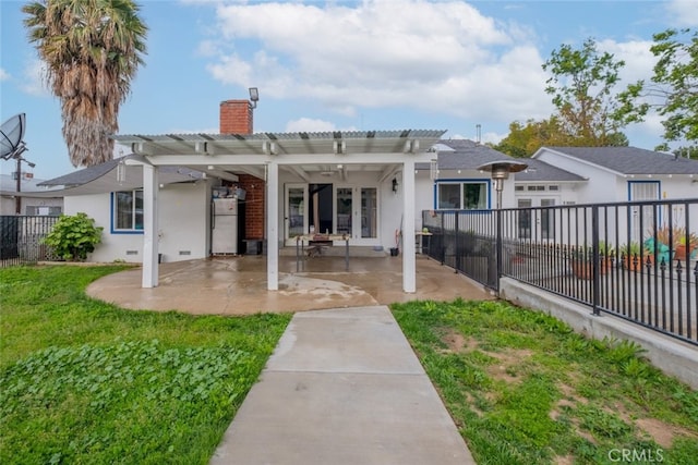 back of house featuring stucco siding, fence, a pergola, and a chimney