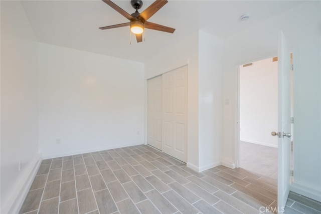 spare room with light wood-style floors and ceiling fan