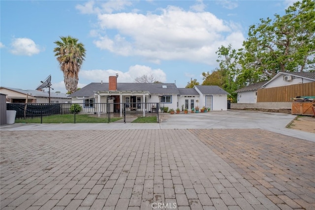 ranch-style home with fence and driveway