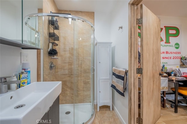 full bathroom with a sink, tile patterned flooring, and a stall shower