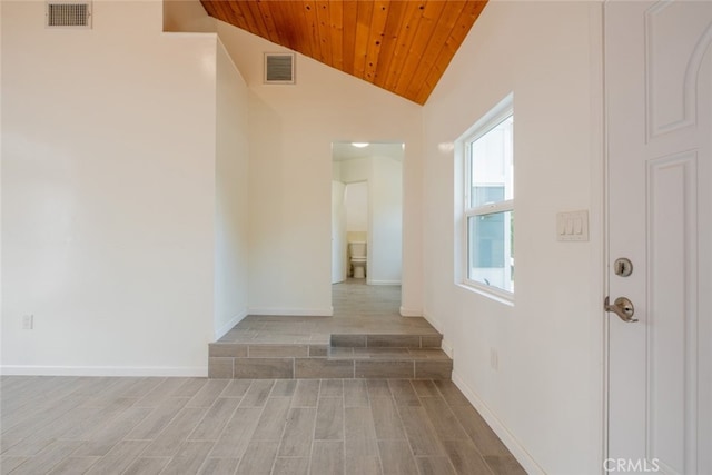 corridor with wood ceiling, wood finish floors, vaulted ceiling, and visible vents