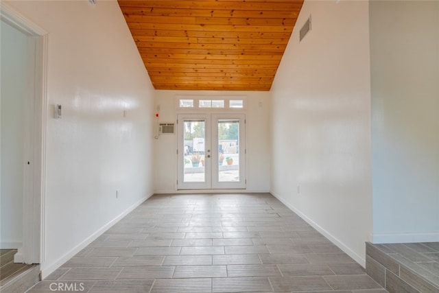 empty room with visible vents, wood ceiling, high vaulted ceiling, and french doors