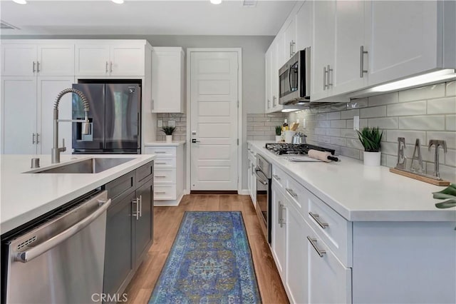 137 Lavender, Lake Forest, CA 92630 - kitchen featuring white cabinets, a sink, light countertops, stainless steel appliances, and recessed lighting