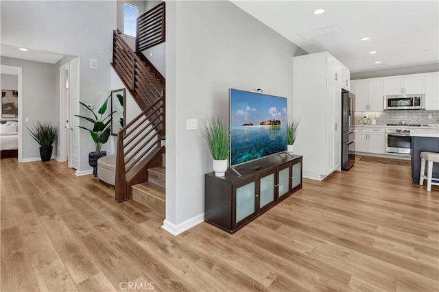 137 Lavender, Lake Forest, CA 92630 - interior space featuring light wood-style floors, baseboards, a high ceiling, and stairs