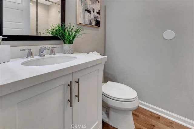 137 Lavender, Lake Forest, CA 92630 - bathroom featuring baseboards, wood finished floors, toilet, and vanity