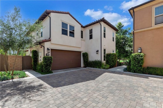 137 Lavender, Lake Forest, CA 92630 - view of front of house featuring a garage, fence, decorative driveway, stucco siding, and a gate