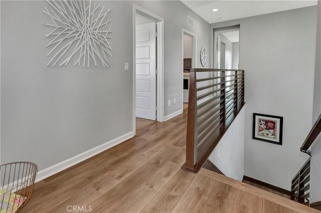137 Lavender, Lake Forest, CA 92630 - hall featuring recessed lighting, baseboards, an upstairs landing, wood finished floors, and visible vents